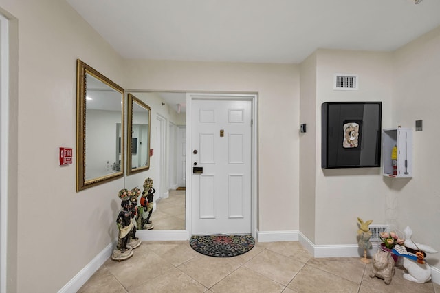 entryway featuring light tile patterned floors and baseboards