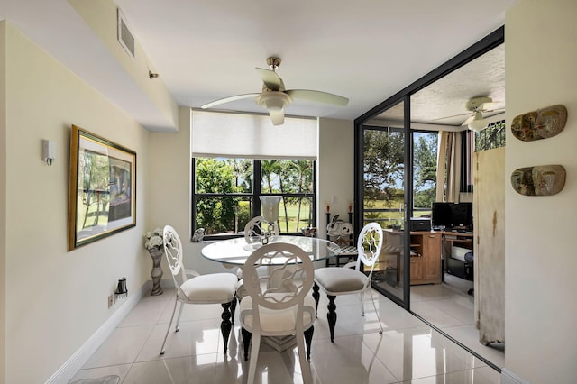 dining room featuring light tile patterned flooring, ceiling fan, baseboards, and a desk