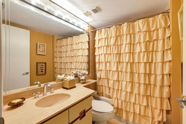 full bathroom featuring toilet, vanity, and shower / tub combo
