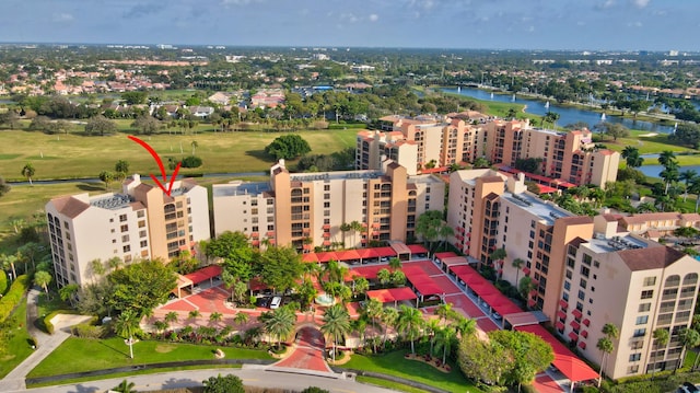 bird's eye view of apartment complex and a large body of water