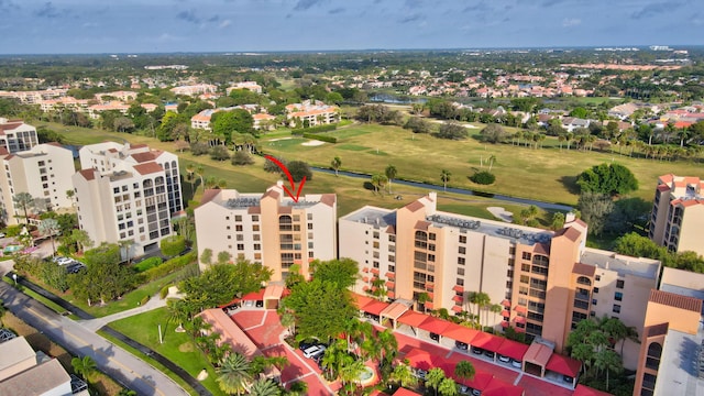 drone / aerial view of apartment complex / building and a golf club