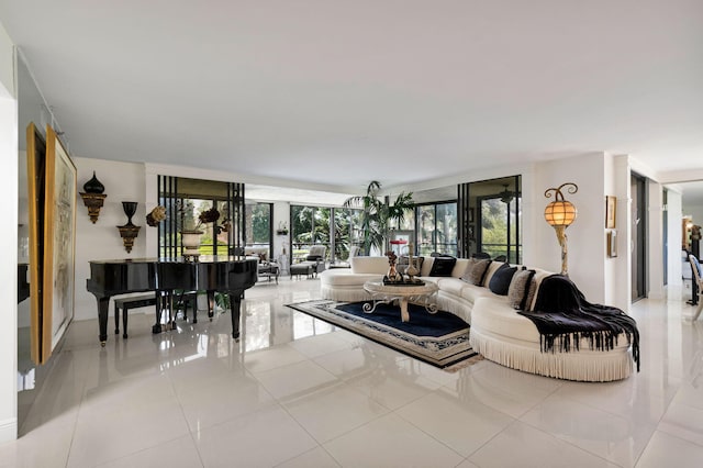 living area with a wall of windows, healthy amount of natural light, and light tile patterned floors
