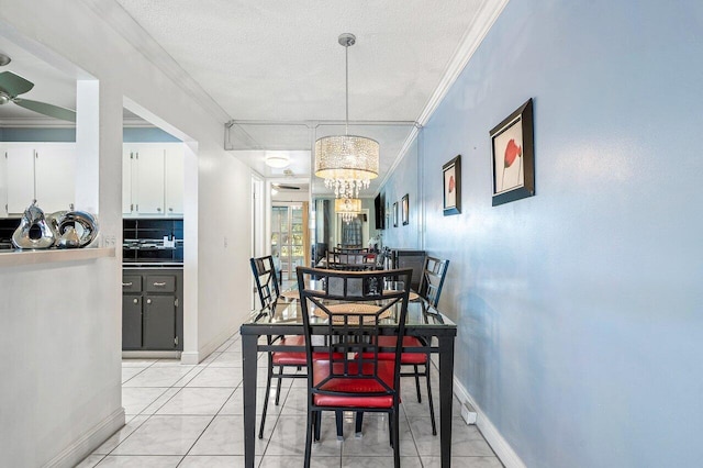 19 Islewood A 19, Deerfield Beach, FL 33442 - dining space with a chandelier, baseboards, a textured ceiling, ornamental molding, and a ceiling fan