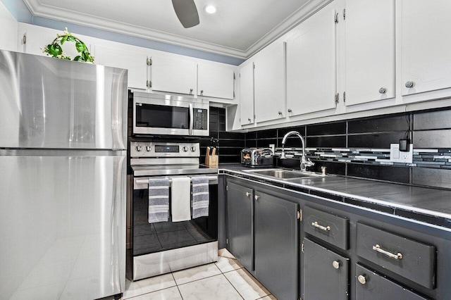 19 Islewood A 19, Deerfield Beach, FL 33442 - kitchen featuring stainless steel appliances, a sink, dark countertops, crown molding, and white cabinetry