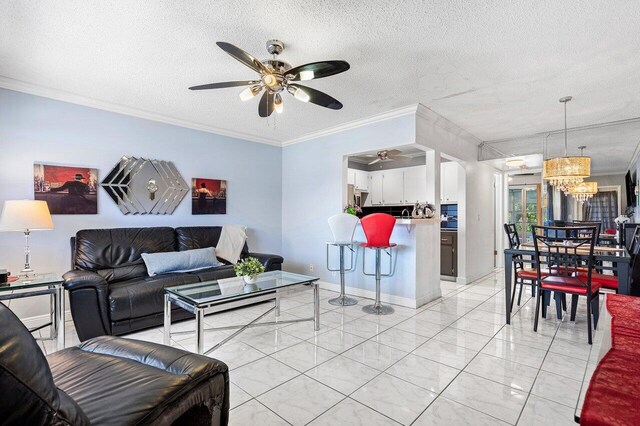 19 Islewood A 19, Deerfield Beach, FL 33442 - living area featuring ornamental molding, a ceiling fan, light marble finish flooring, a textured ceiling, and a chandelier