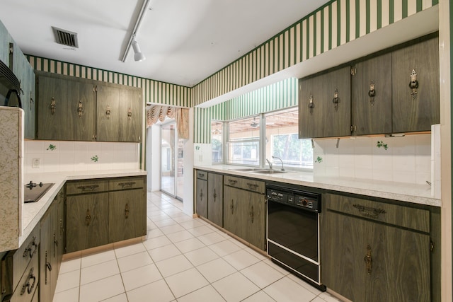 kitchen featuring black appliances, decorative backsplash, light countertops, and wallpapered walls