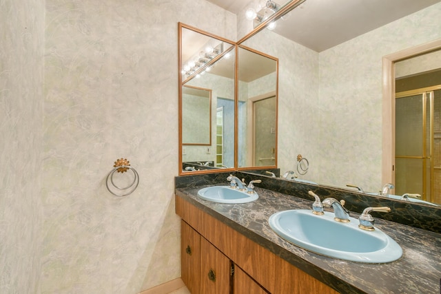 full bath featuring double vanity, tile patterned floors, and a shower with door