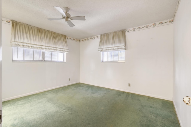 carpeted spare room featuring a ceiling fan, baseboards, and a textured ceiling