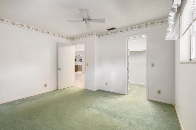 spare room with carpet flooring, ceiling fan, and baseboards
