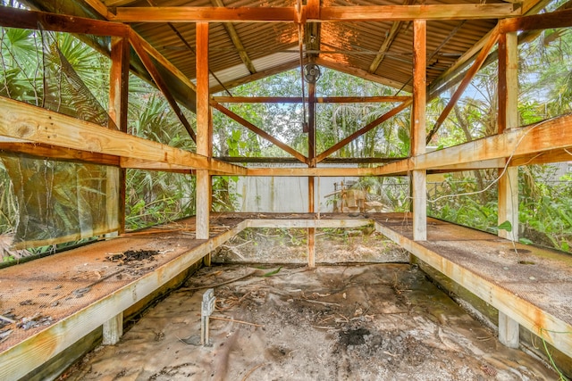 unfurnished sunroom featuring vaulted ceiling