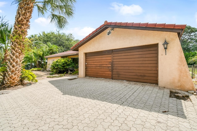 garage with decorative driveway
