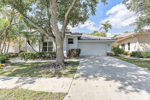 7793 Highlands Cir, Margate, FL 33063 - view of front of home with a garage, a tiled roof, stucco siding, and concrete driveway