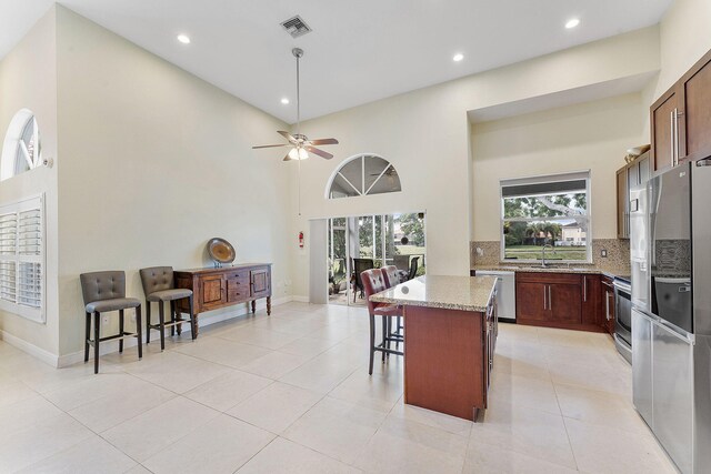 7793 Highlands Cir, Margate, FL 33063 - kitchen with appliances with stainless steel finishes, a breakfast bar area, a center island, recessed lighting, and ceiling fan