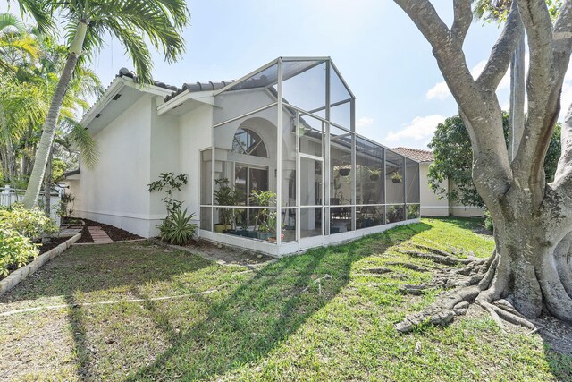 7793 Highlands Cir, Margate, FL 33063 - back of house featuring a lawn, a tiled roof, stucco siding, and a lanai