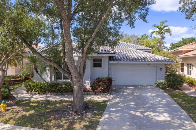 7793 Highlands Cir, Margate, FL 33063 - view of front of property with an attached garage, stucco siding, concrete driveway, and a tiled roof