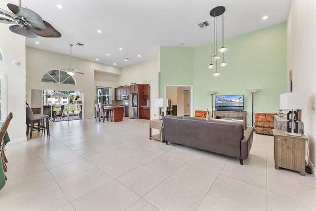 7793 Highlands Cir, Margate, FL 33063 - living room featuring a high ceiling, ceiling fan, light tile patterned flooring, recessed lighting, and baseboards