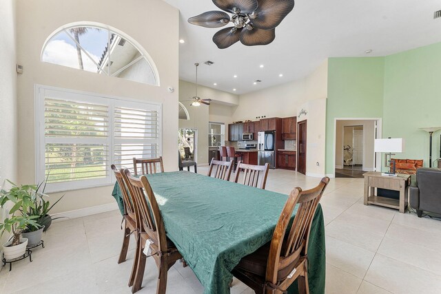 7793 Highlands Cir, Margate, FL 33063 - dining room featuring a high ceiling, a ceiling fan, healthy amount of natural light, baseboards, and light tile patterned floors