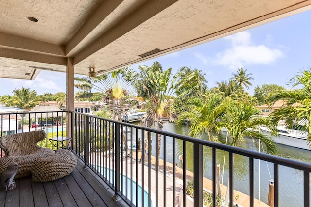 balcony featuring a water view and view of pool
