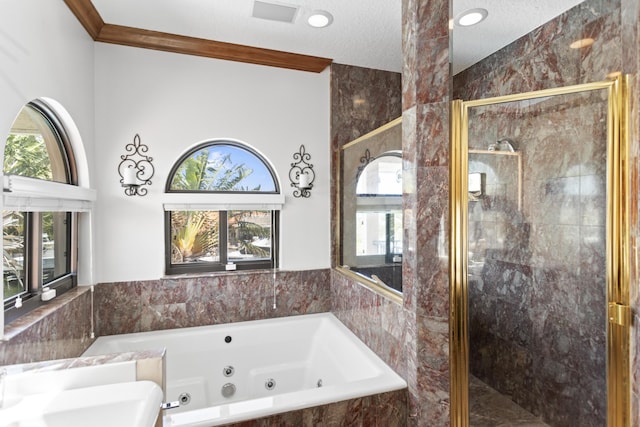 full bath featuring a jetted tub, a shower stall, a textured ceiling, and tile walls