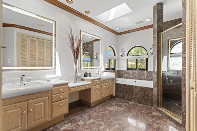 full bath with a skylight, crown molding, a garden tub, two vanities, and a stall shower