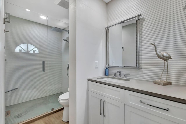 3704 Fairway Dr N, Jupiter, FL 33477 - full bathroom with toilet, a shower stall, vanity, wood finished floors, and recessed lighting