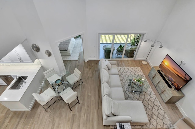 3704 Fairway Dr N, Jupiter, FL 33477 - living room with a high ceiling, wood finished floors, and baseboards