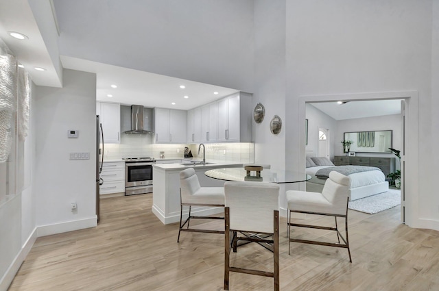 3704 Fairway Dr N, Jupiter, FL 33477 - dining room with light wood finished floors, baseboards, a towering ceiling, and recessed lighting