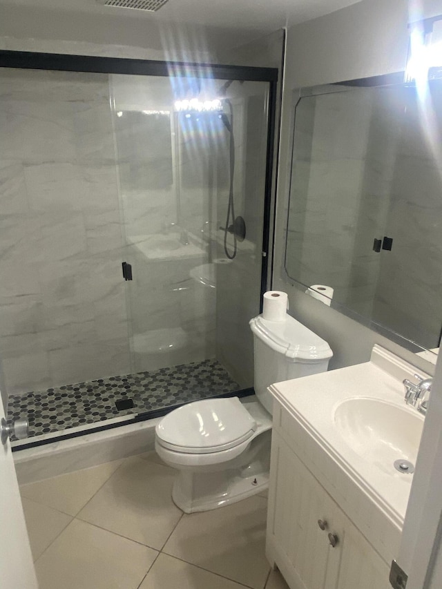 719 Sunny Pine Way Unit G1, Greenacres, FL 33415 - bathroom with toilet, a stall shower, tile patterned floors, and vanity