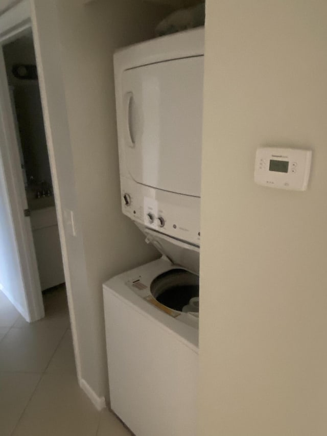 719 Sunny Pine Way Unit G1, Greenacres, FL 33415 - laundry area with stacked washing machine and dryer and tile patterned flooring