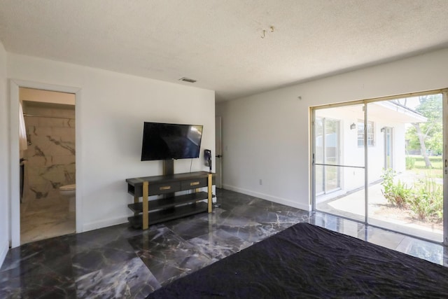 living area featuring marble tiled floors, a textured ceiling, and baseboards