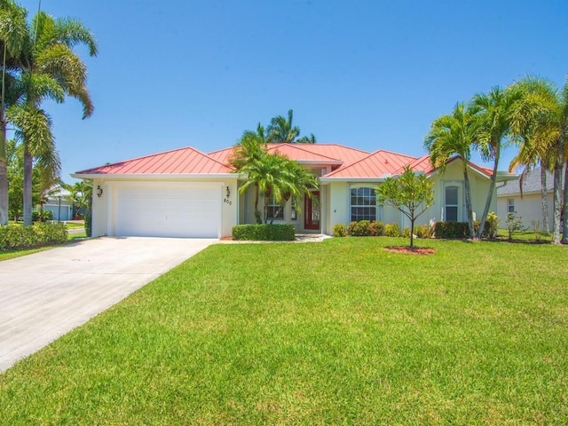 800 Alexandra Ave SW, Vero Beach, FL 32968 - ranch-style home with a standing seam roof, metal roof, an attached garage, a front lawn, and concrete driveway