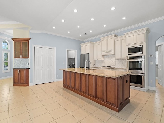 800 Alexandra Ave SW, Vero Beach, FL 32968 - kitchen with appliances with stainless steel finishes, crown molding, cream cabinetry, decorative backsplash, and light tile patterned flooring