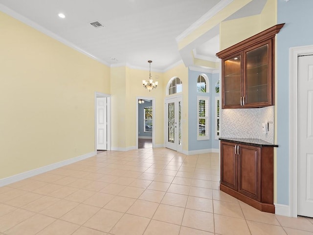 800 Alexandra Ave SW, Vero Beach, FL 32968 - unfurnished dining area with a chandelier, light tile patterned floors, crown molding, baseboards, and recessed lighting