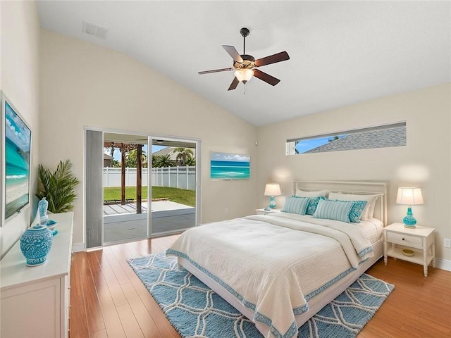 800 Alexandra Ave SW, Vero Beach, FL 32968 - bedroom with access to exterior, multiple windows, light wood finished floors, baseboards, and high vaulted ceiling