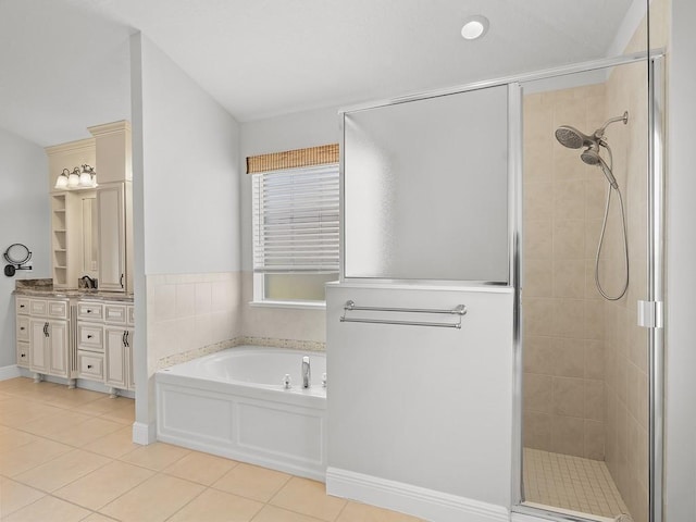 800 Alexandra Ave SW, Vero Beach, FL 32968 - full bath with a shower stall, tile patterned flooring, vanity, and a garden tub