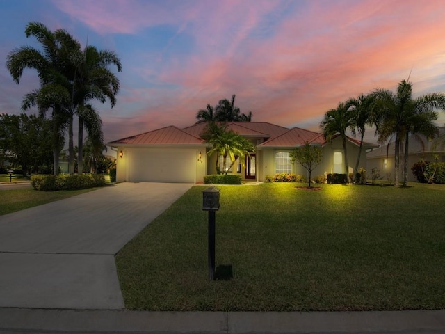 800 Alexandra Ave SW, Vero Beach, FL 32968 - view of front facade with concrete driveway, metal roof, a standing seam roof, and a garage