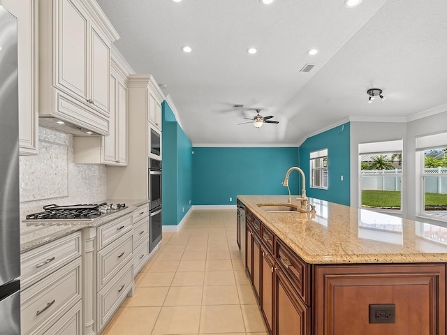 800 Alexandra Ave SW, Vero Beach, FL 32968 - kitchen with a sink, appliances with stainless steel finishes, a ceiling fan, tasteful backsplash, and light tile patterned floors