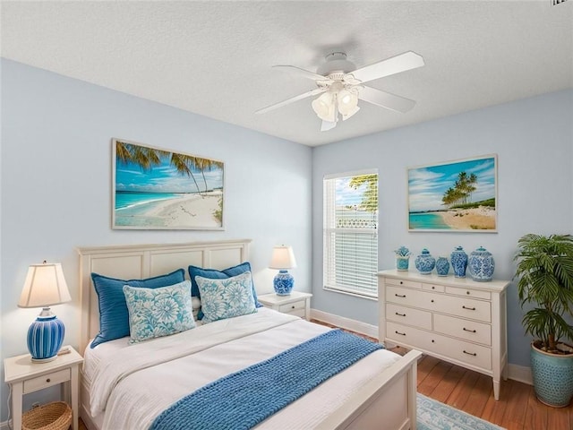 800 Alexandra Ave SW, Vero Beach, FL 32968 - bedroom featuring wood finished floors, baseboards, a textured ceiling, and a ceiling fan
