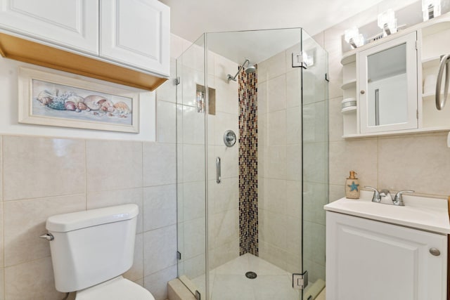 2520 Black Olive Blvd Unit 103, Delray Beach, FL 33445 - full bath featuring tile walls, a stall shower, vanity, and toilet