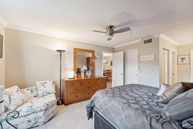 2520 Black Olive Blvd Unit 103, Delray Beach, FL 33445 - bedroom with ornamental molding, a closet, light tile patterned floors, a ceiling fan, and a textured ceiling