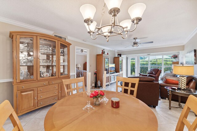 2520 Black Olive Blvd Unit 103, Delray Beach, FL 33445 - dining area featuring ceiling fan, light tile patterned flooring, ornamental molding, and a chandelier