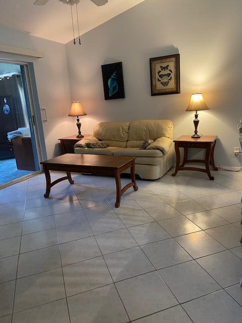378 NW Sherry Ln, Port Saint Lucie, FL 34986 - living room with light tile patterned floors and a ceiling fan