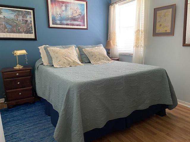 378 NW Sherry Ln, Port Saint Lucie, FL 34986 - bedroom featuring wood finished floors and baseboards