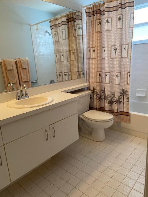 378 NW Sherry Ln, Port Saint Lucie, FL 34986 - bathroom featuring tile patterned flooring, toilet, vanity, and shower / bath combo