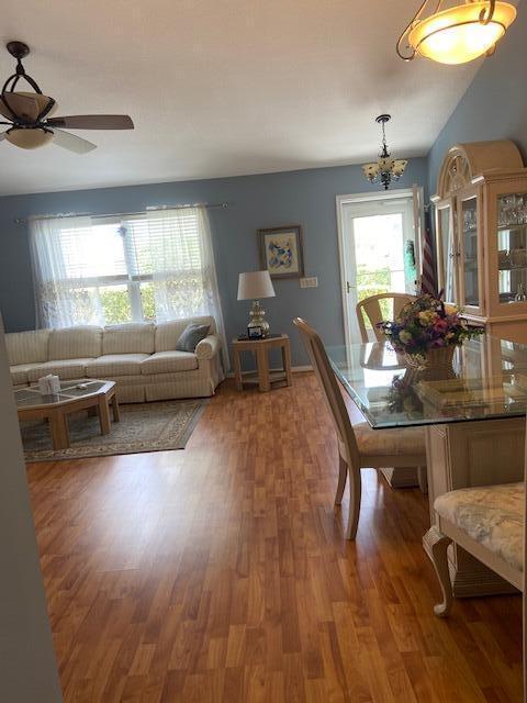 378 NW Sherry Ln, Port Saint Lucie, FL 34986 - dining space with a ceiling fan, a chandelier, and light wood finished floors