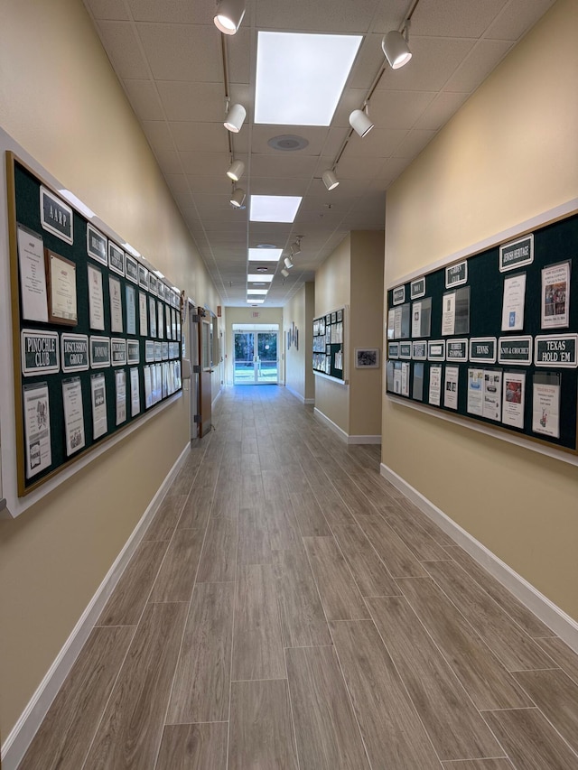 378 NW Sherry Ln, Port Saint Lucie, FL 34986 - hallway featuring rail lighting, wood finished floors, and baseboards