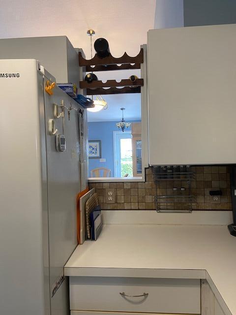 378 NW Sherry Ln, Port Saint Lucie, FL 34986 - detailed view of freestanding refrigerator and backsplash