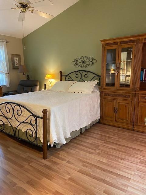 378 NW Sherry Ln, Port Saint Lucie, FL 34986 - bedroom featuring vaulted ceiling, light wood-type flooring, and ceiling fan