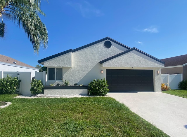 ranch-style house with stucco siding, an attached garage, and concrete driveway