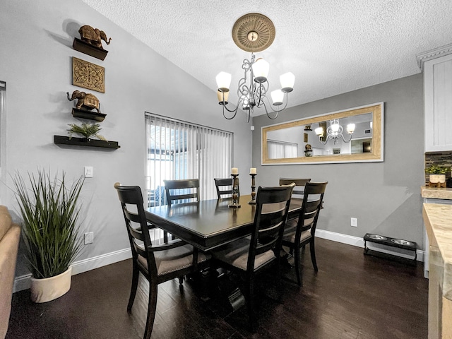 dining room featuring a textured ceiling, a chandelier, baseboards, and dark wood finished floors